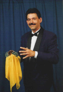 Magician Cecil Lewis producing coins from the air